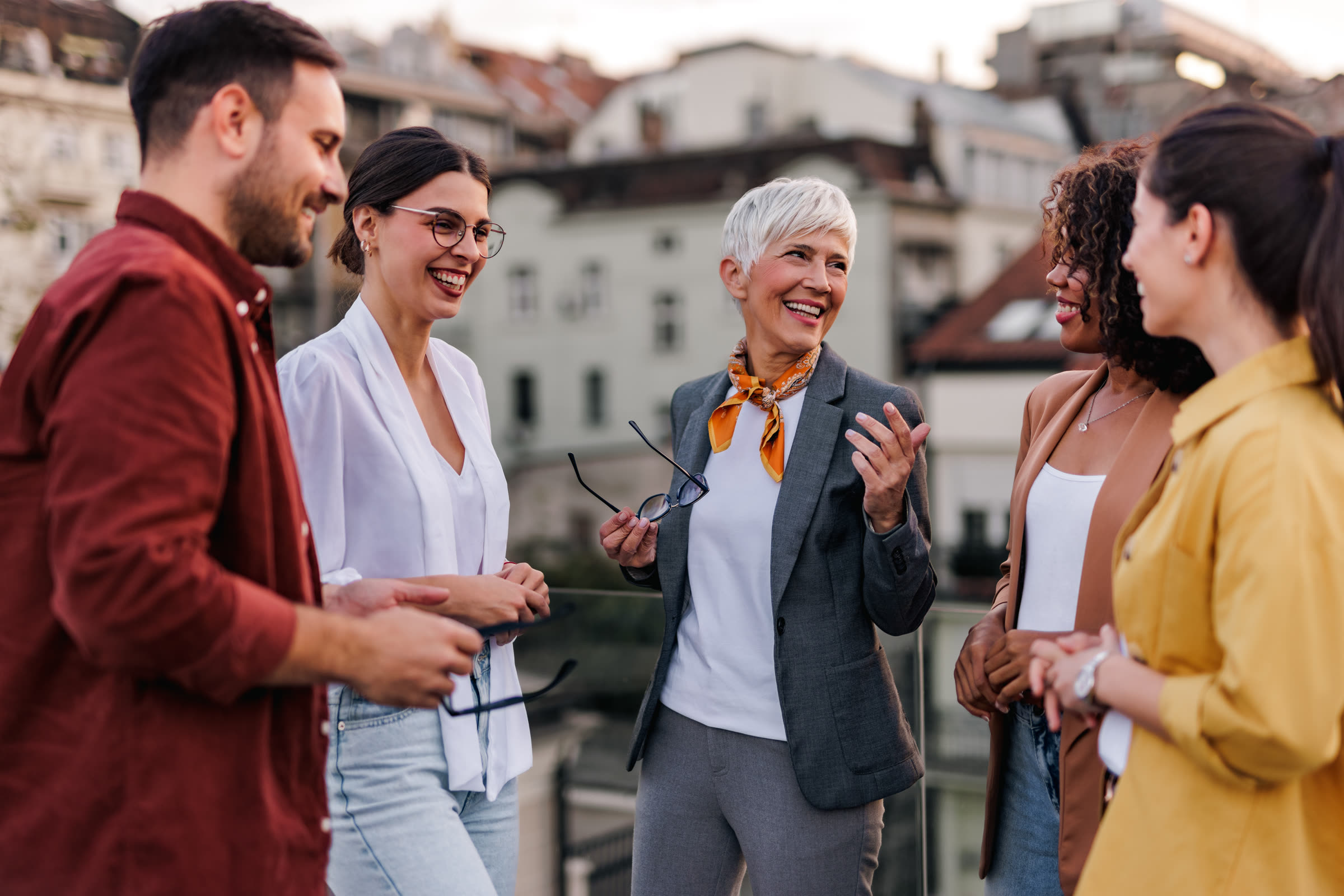 Business colleagues standing together on a terrace