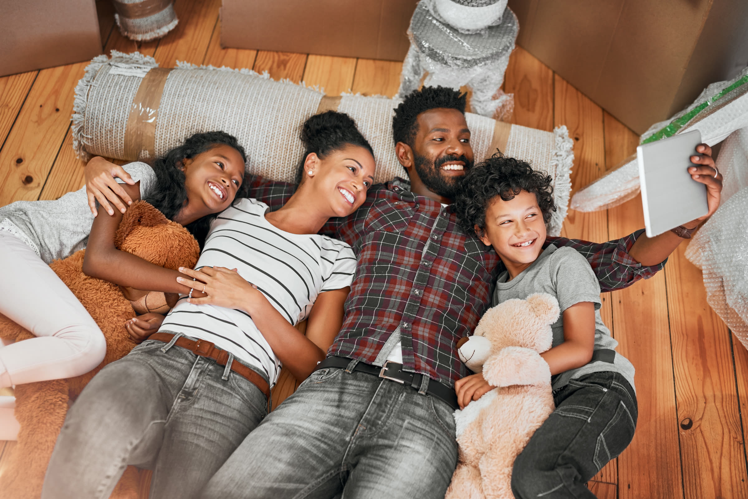 Smiling family taking a photo while moving into a new home